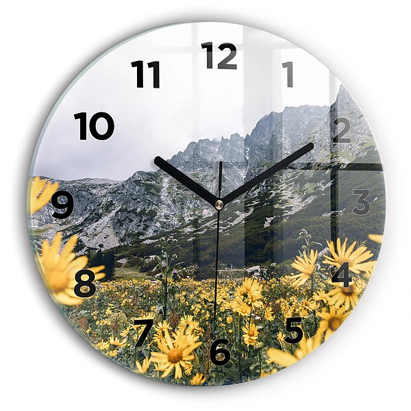 Wanduhr rund Blumenwiese in den Bergen