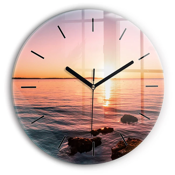 Wanduhr glas rund Felsen bei Sonnenuntergang