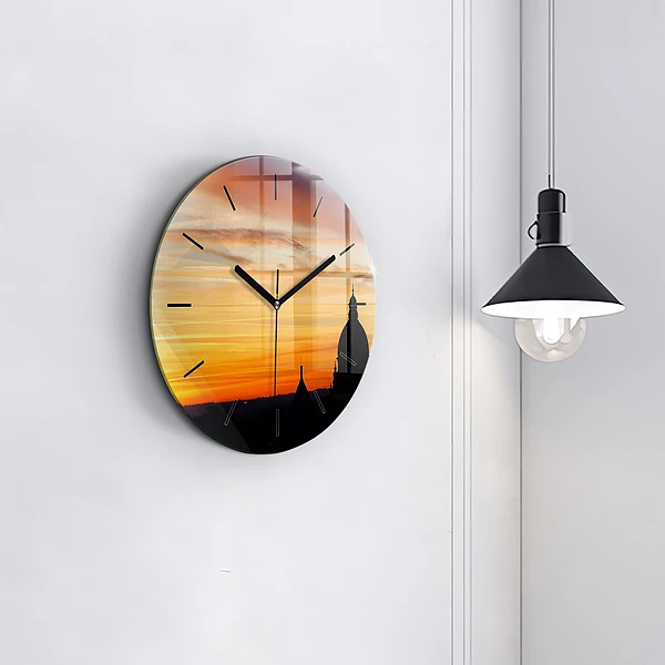 Wanduhr rund Gebäude und Sonnenuntergang